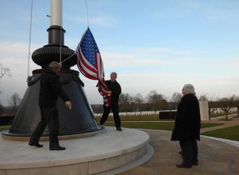 Arthur Brookes and Howard Slatter lowering the flag, Cambridge American Cemetery, Local History Group visit. Photo: Andrew Roberts, 1 March 2015.