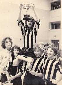 Trumpington Tornadoes with the under-13 cup held by Trudie Mahoney, the only girl in the competition, January 1976. With Trudie Mahoney, left to right: Tim Holmes, Gary Haylock, Ken Smith, Andy Caudwell and Laurence Cullen. [Source: Mrs Anna Smith]