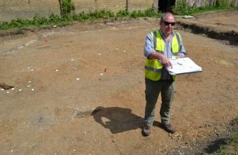 Richard Mortimer talking to a group at the excavation, with white tags marking Late Saxon post holes, Anstey Hall Farm. Photo: Andrew Roberts, 10 May 2015.