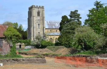 View across the excavated area to the church, Anstey Hall Farm. Photo: Andrew Roberts, 10 May 2015.
