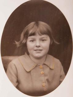 Audrey Rayner age about 8, in a dress made by Miss Kitty Willers. Source: Audrey King, copy photo by Howard Slatter, March 2017.