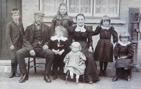 The Rayner family, at the back of 3 Stockton Cottages, Church Lane. Andrey Rayer's Uncle George, grandfather, father, Aunt Annie, Aunt Olive, grandmother, Aunt Nell and Aunt Louie, about 1899. Source: Audrey King, copy photo by Howard Slatter, March 2017.