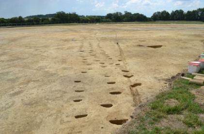 Lines of Bronze Age post holes and adjacent ditches on the Bell School archaeological site. Photo: Andrew Roberts, 25 July 2014.