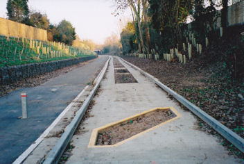 The completed busway through the former railway cutting, looking east from under Hauxton Road bridge, early 2011.