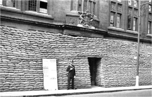 Cover illustration for Cambridge at War: the Police Station, St Andrew’s Street, Cambridge, with wartime defences, 1939. Cambridgeshire Collection, Cambridge Central Library.