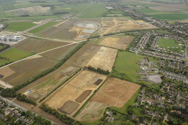 Oblique aerial view of the archaeological excavation on Clay Farm looking south from Long Road to Addenbrooke’s and Trumpington. Source: Oxford Archaeology East, 13 April 2011.