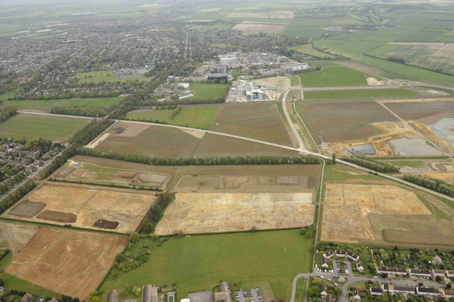 Oblique aerial view of the archaeological excavation on Clay Farm looking east from Trumpington to Long Road and Addenbrooke’s, with excavations underway in the fields to the east of Wingate Way, CPDC and Foster Road. Source: Oxford Archaeology East, 13 April 2011.