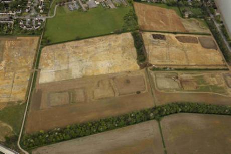 Aerial view of the archaeological excavation on Clay Farm, looking east from the green corridor to CPDC and Wingate Way, with Long Road to the right and Clay Farm House upper right. Source: Oxford Archaeology East, 13 April 2011.