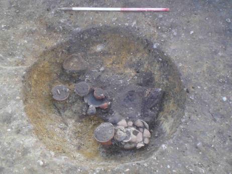 Finds in situ in the cremation pit. Source: Oxford Archaeology East, 9 February 2011.