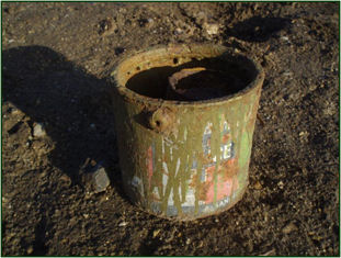 Paint tin with a baked-bean tin inside, found on the site of the World War 2 searchlight. Oxford Archaeology East, 2011.