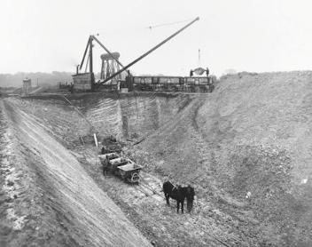 Coprolite digging in Trumpington during World War I, deep pit and trucks, c. 1917-18. Photo: Courtesy of Henry Boot and Son.