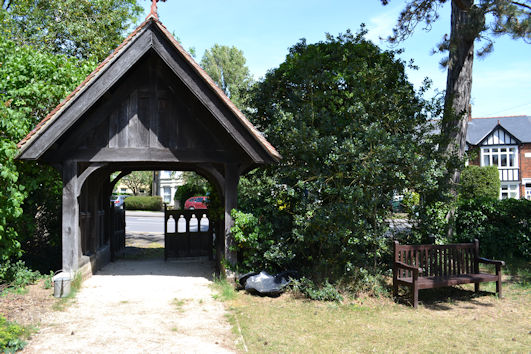 The 'Coronation' bench and the entrance to Trumpington Churchyard Extension, Shelford Road. Photo: Andrew Roberts, 18 May 2022.