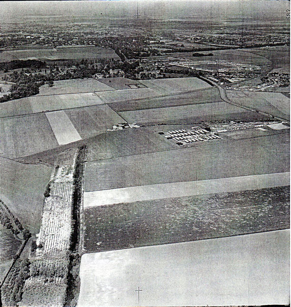 Looking north east over Anstey Hall farm towards Trumpington village, with the World War 1 coprolite workings and channels in foreground lower left, shepherd’s cottage and World War 2 Prisoner of War Camp centre right, Hauxton Road to the right and crossed in the distance by the Cambridge-Bedford railway. Cambridge University Collection of Aerial Photographs, EW4, 3 June 1950.