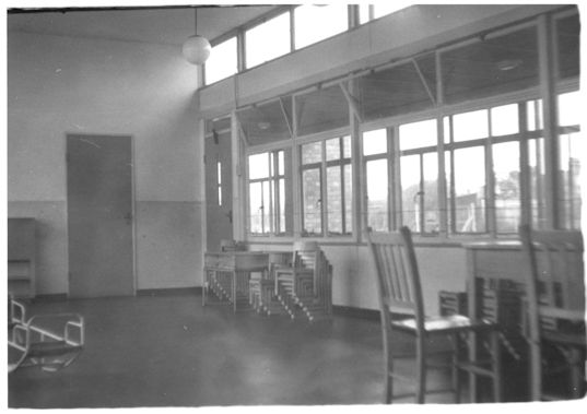 Fawcett School, interior with stacked chairs, 1950s. Photograph: Cambridgeshire Collection.