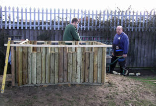 Parents and Graham Bass building a play fort for infants, 2009. Source: Fawcett School.