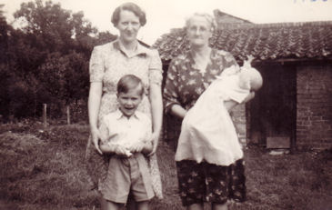 Brian Goodliffe, mother, maternal grandmother and brother, summer 1950, in the back yard of 18 Grantchester Road