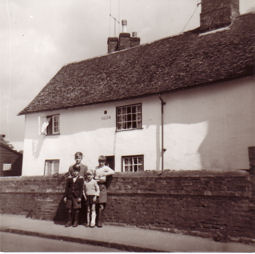 Dated Cottages, 18 Grantchester Road, 13 July 1957, from Grantchester Road, showing the Sun-Fire Insurance Company plaque and the 1654 date. With Brian Goodliffe, rear left (aged 13), Michael Goodliffe, front left (aged 7) and the younger boys of the Parr family. Photo: Goodliffe family.