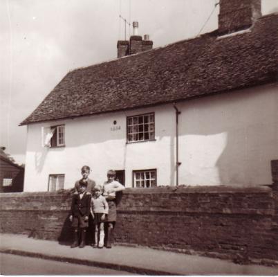 Dated Cottages, 18 Grantchester Road, 13 July 1957, from Grantchester Road, showing the Sun-Fire Insurance Company plaque and the 1654 date. With Brian Goodliffe, rear left (aged 13), Michael Goodliffe, front left (aged 7) and the younger boys of the Parr family (who may have been living in the adjacent cottage). Photo: Goodliffe family.