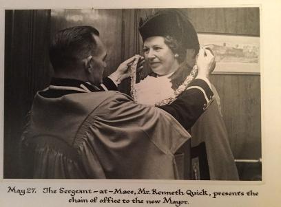 The appointment of Jean Barker as Mayor of Cambridge, 27 May 1971. Photograph in Baroness Trumpington's archive, captioned "May 27 1971: The Sergeant-at-Mace, Mr. Kenneth Quick, presents the chain of office to the new Mayor." Photo: Adam Barker, October 2019.
