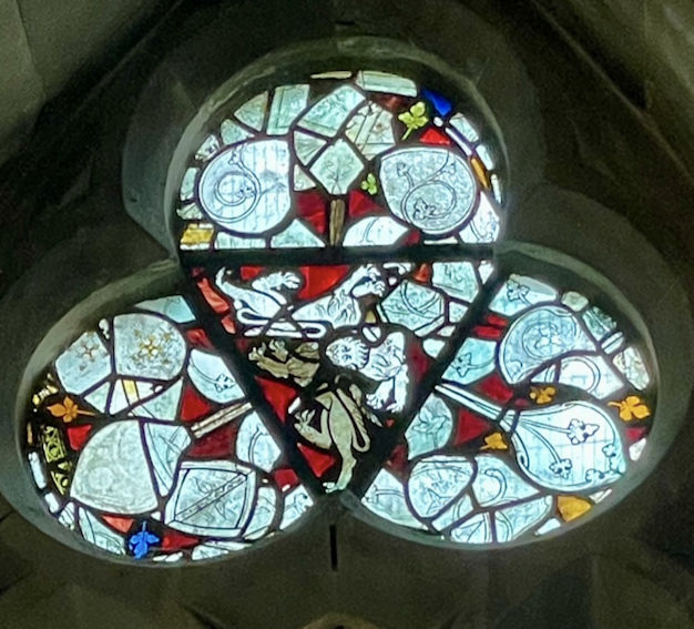 Trefoil window on the north side of the chancel, with thirteenth-century glass forming an image of three lions or leopards, Trumpington Parish Church. Photo: Jo Sear, 2023.