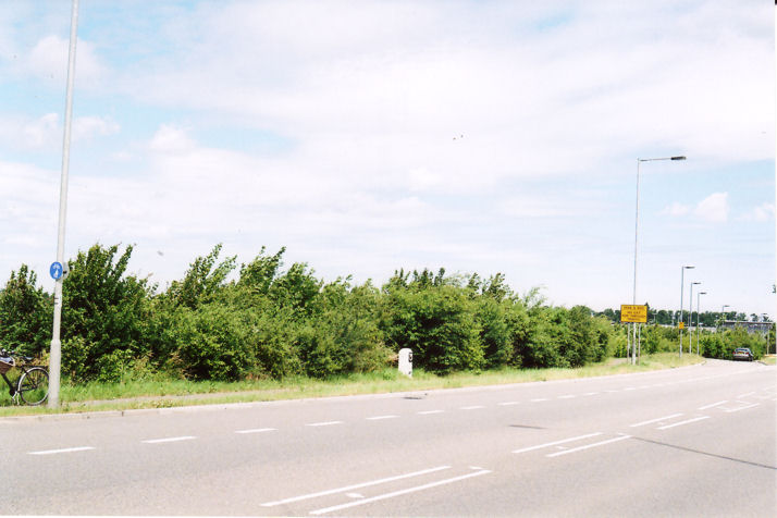 The third milestone on Hauxton Road before it was removed in preparation for road widening, with the slip road into the Park & Ride site and the John Lewis building in the distance. Photo: Andrew Roberts, 27 June 2008.