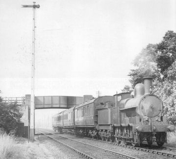 Local passenger train in LMS days hauled by an ex-LNWR goods locomotive, running from Cambridge to Bedford, passing under Long Road bridge, Trumpington. Reproduced with permission from Bletchley to Cambridge (image 106), by Vic Mitchell and Keith Smith, 2007, published by Middleton Press.