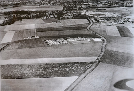 Aerial photograph of the Plant Breeding Institute (PBI) site and Trumpington village, from the south, including Hauxton Road, the PoW Camp, shepherd's cottage, village centre with the estate, c. 1950. Source: Michael Hendy.