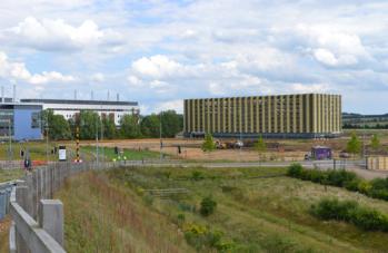 Archaeological work on the Papworth site with the new car park, from the busway bridge. Photo: Andrew Roberts, 30 June 2014.