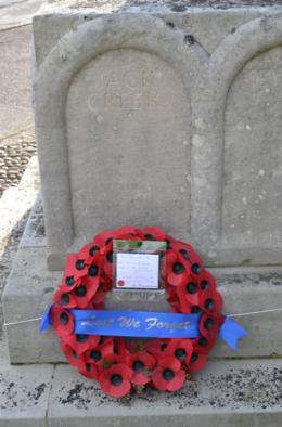 The wreath in memory of Lieutenant Jack Creek underneath the newly added inscription commemorating �Jack Creek�, Trumpington War Memorial, Remembrance Sunday, 9 November 2014.
