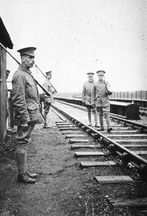 Trumpington Volunteer Training Corps guarding the railway line over the river bridge �Somewhere in Cambs.�, November 1915. This photograph by �Haslop, Trumpington� was reproduced in Cambridge Chronicle, 17 November 1915, page 7. Percy Robinson collection. Left to right: 1) P.J. Collins (sentry); P.R. Robinson (sergeant); T.H.J. Porter (patrol); W.R. Haslop (patrol).