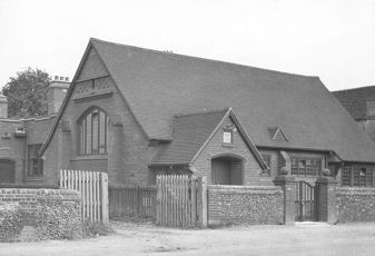 Trumpington Village Hall, after the 1924 alterations, with the entrance to Manor Farm to the left. Percy Robinson collection.