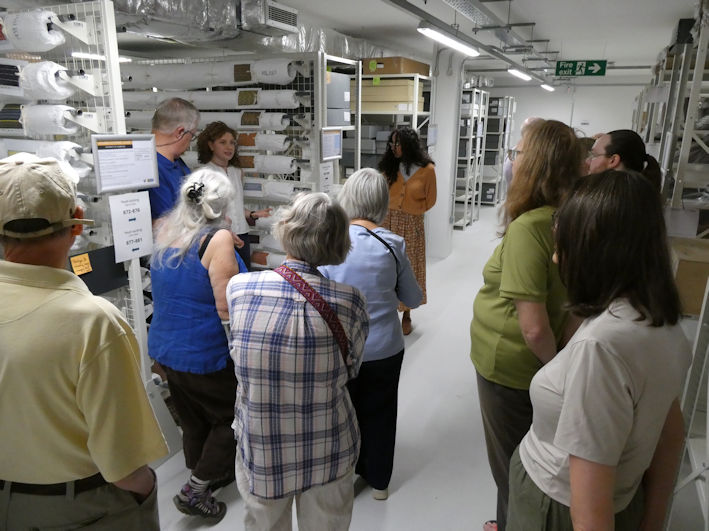 Rosie Croysdale talking to the group beside the textile storage, the Centre for Material Culture. Photo: Andrew Roberts, 4 August 2026.