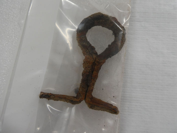 An iron eyelet, part of the fittings of the bed burial found at Trumpington Meadows, the Centre for Material Culture. Photo: Andrew Roberts, 4 August 2026.