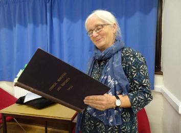 Philippa Slatter at the Local History Group meeting about local Mayors, talking about Eva Hartree, with the Council minute book for 1925. Photo: Andrew Roberts, 26 September 2019.