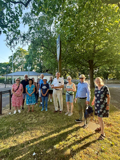 Participants on the Local History Group walk around old Trumpington and the parish church, at the village sign. Photo: Jo Sear, 19 June 2025.