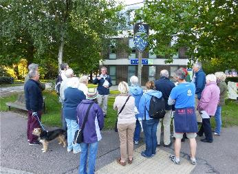 Andrew Roberts talking to participants at the Village Sign, Trumpington Local History Group walk. Martin Jones, 10 September 2015.