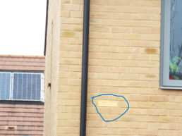One of the gold bricks in situ on a home. Photo: Randall Evans, February 2024.