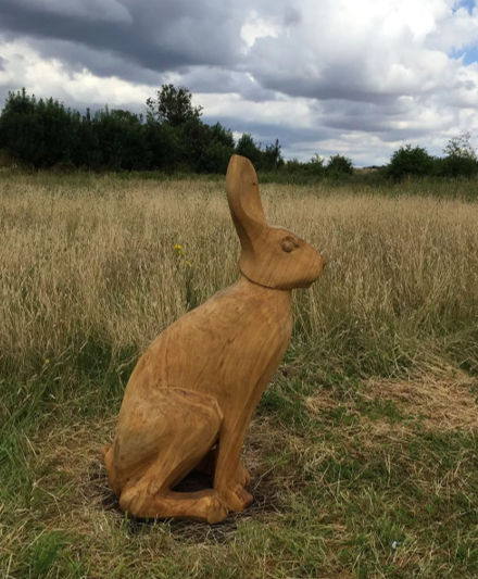 Original carving of a hare on the Country Park meadow.