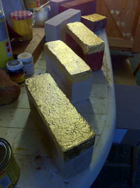A group of golden bricks in the studio, to be installed in the exterior walls of homes that are built on the line of demolished PBI buildings. Photo: Caroline Wright, 2 February 2012.
