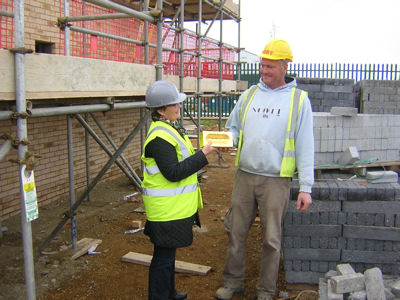 Preparing to place one of the golden bricks on a Trumpington Meadows home, marking the layout of the PBI site, with Caroline Wright, April 2012. Photo: Nick Milne, Cambridge City Council.