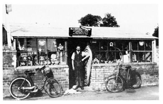 Harry Newell in front of his shop.