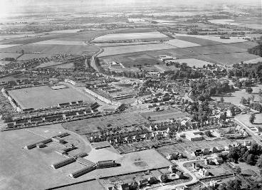 Aerial view of Trumpington looking south, with Alpha Terrace, Fawcett School and allotments at the bottom, the new estate in the centre and Shelford Road and Hauxton Road in the distance, c. 1955. W Stanion (Stephen Brown).