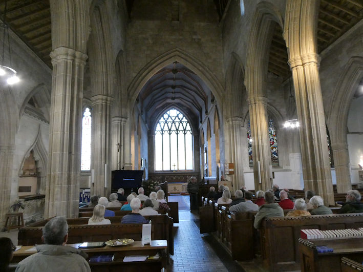 Jo Sear introducing David Newcombe at the Local History Group meeting in Trumpington Church. Photo: Andrew Roberts, 7 May 2026.
