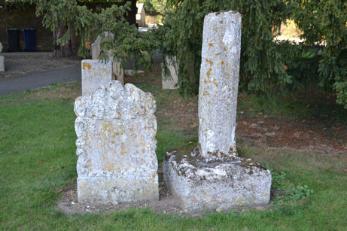 The base of the churchyard cross and an adjacent headstone dated 1719, to the north side of Trumpington Church. Pghoto: Andrew Roberts, October 2011.