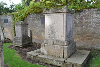 The Hemington Harris family monuments to the right of the path beyond the church tower (entry 9). Photo: Andrew Roberts, 27 October 2013.