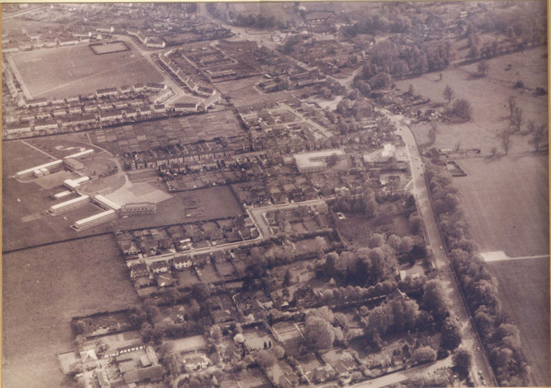 Aerial view of Trumpington from the north, 1964. Includes the village core, High Street, Church Lane, the Estate and King George V recreation ground, Anstey Way, Alpha Terrace, Fawcett School, allotments. Source: Barry Thompson.